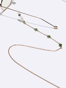 Fashionable gold chain eyewear holder with green crystal accents and adjustable loops