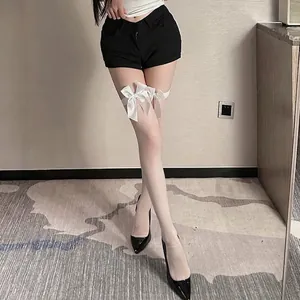 White stay-up stockings featuring elegant satin bows and sheer fabric for women