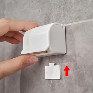 Wall-mounted white manual razor holder and storage hook with adhesive mount for bathroom
