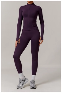 Detail of dark purple seamless yoga set showing thumb holes and high-waist compression fit