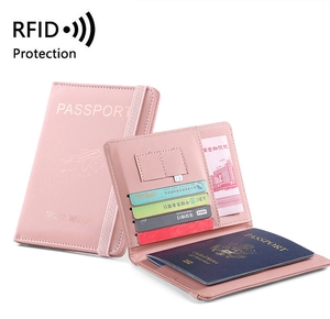 Pink PU leather RFID passport holder with multiple card slots and elastic closure strap