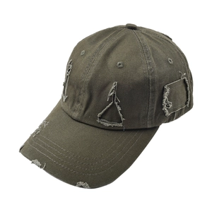 Detail of distressed olive green baseball cap showing worn edges and washed cotton texture