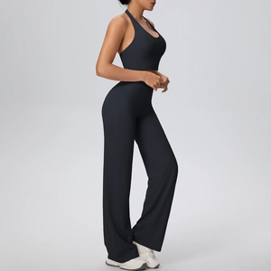Side view of black halter-neck sports bra and high-waisted wide-leg yoga pants set