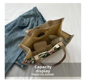 Internal view of canvas tote bag showing large capacity with magnetic buckle and zip pocket