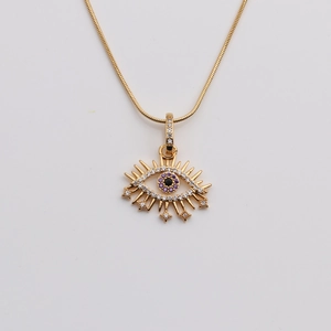 Close-up of gold-plated eye pendant necklace with purple zircon inlay and snake chain