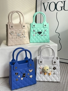 Detail of colorful EVA beach bags with DIY decorative charms and lattice texture