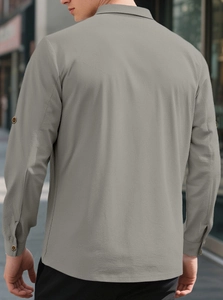 Detail of grey linen shirt fabric texture with adjustable sleeve tabs on the back