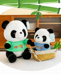 Adorable pair of panda plush dolls wearing green and blue China t-shirts, soft souvenir toys.