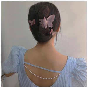 Three-piece frosted butterfly hair claw set in pink, styled on a neat hair bun