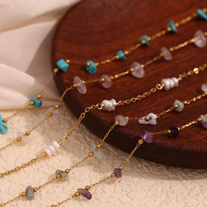 Detailed close-up of 18K gold-plated anklet with natural pearl and colorful gemstones