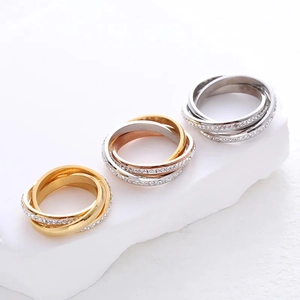 Three-color interlocking rings in gold and silver finish with sparkling pavé stones