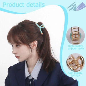 Detail view of light blue pencil hair claw clip featuring golden teeth and strong springs