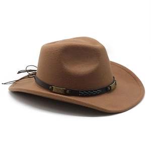 Detail of brown cowboy hat featuring black leather band with rivets and embroidery