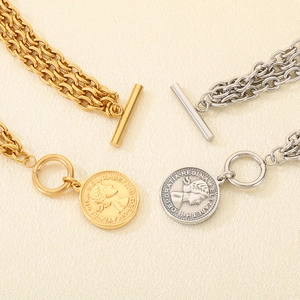 Layered stainless steel coin pendant bracelet with OT toggle clasp in gold and silver