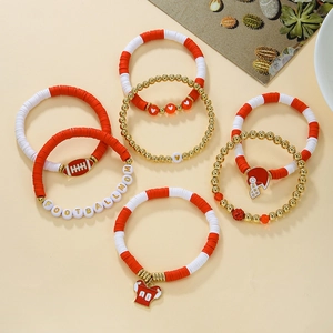 Detail of multi-layer clay bead bracelets with football charms and Football Mom letters
