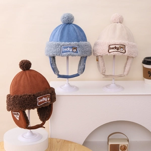 Winter trapper hat for kids featuring plush bear embroidery and warm faux fur lining