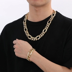 Close-up of gold iced-out Cuban link necklace and bracelet set worn by a male model