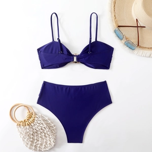 Flat lay of navy blue bikini with thin straps, metal buckle detail and high waist bottom
