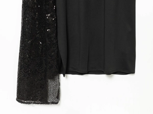 Detail of sequin mesh splicing with smooth black fabric on a midi dress hem