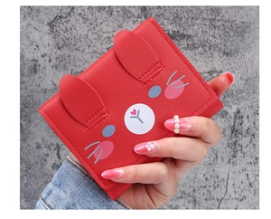 Detail of a red cartoon rabbit wallet with 3D ears and cute facial print