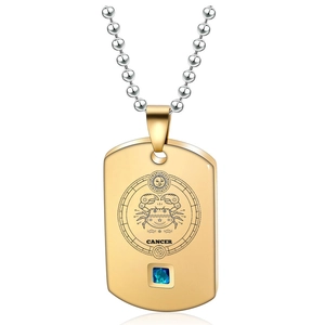 Detail of gold Cancer zodiac dog tag pendant with blue gemstone on a ball chain