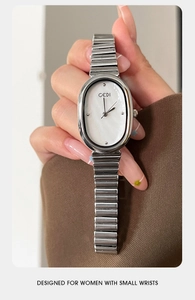 Close-up of GEDI silver women's oval watch with white pearl dial on a delicate wrist