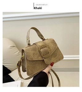 Detailed shot of khaki crossbody bag with vintage denim texture and bronze square buckle