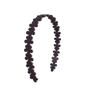 Close-up of chocolate brown matte acrylic flower headband showing petal texture