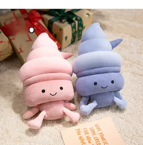 Detailed view of plush ice cream pillows in pink and blue with embroidered faces