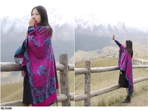 Detailed view of paisley patterns and black tassels on thick purple cashmere shawl