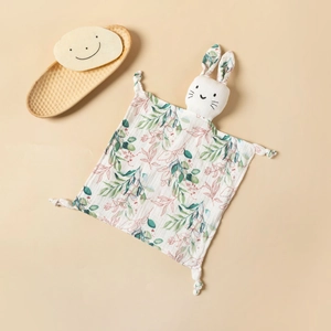 Detail of baby cotton muslin security blanket with bunny head and leaf pattern