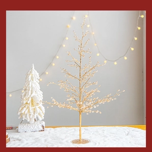 Close-up of golden beaded Christmas tree ornament with metal wire and crystals