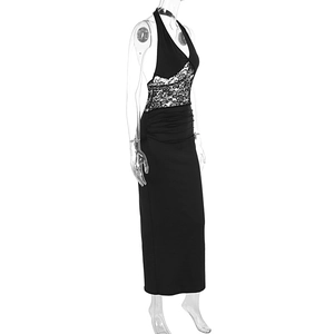 Detail of elegant black halter gown featuring white floral lace and side ruching