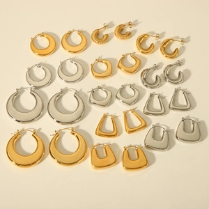 Detailed flat lay of assorted 18K gold and silver stainless steel geometric earrings