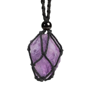 Macro shot of natural raw amethyst stone pendant in a black hand-woven net cord bag