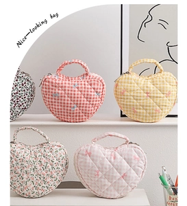 Variety of heart-quilted cosmetic bags featuring floral patterns and color checkered designs