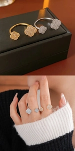 Close-up and on-hand display of a gold and silver four-leaf clover zircon open ring