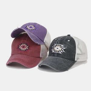 Close-up of distressed ponytail caps with vintage embroidery and breathable mesh back