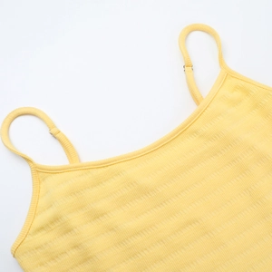 Detail of yellow ribbed knit sundress showing neckline and delicate shoulder straps