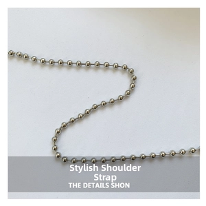 Close-up of a glossy silver beaded metal chain shoulder strap for stylish handbags