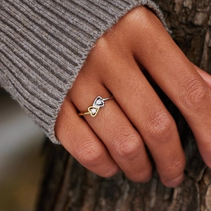 Close-up of S925 sterling silver bypass ring with gold and silver heart zircon stones