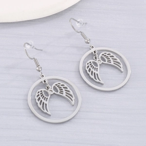 Detail of silver stainless steel angel wing earrings with crystal rhinestones
