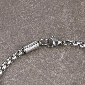 Silver stainless steel box chain bracelet featuring lobster clasp and cylindrical charms