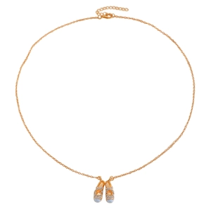 Detailed view of golden ballet slipper pendant with sparkling crystals and blue enamel