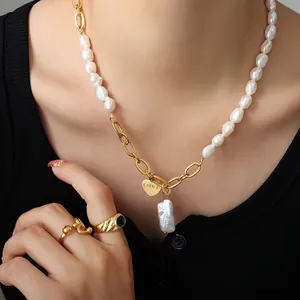 Baroque pearl necklace with gold LOVE heart pendant and emerald ring on model