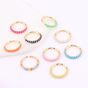 Detail of colorful enamel drip open rings in multiple vibrant colors on gold bands