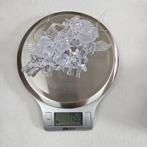 Detailed close-up showing the weight of transparent acrylic angel tree ornaments
