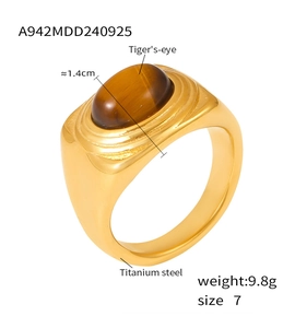 Detailed macro view of an oval tiger eye stone set in a vintage gold-plated titanium ring