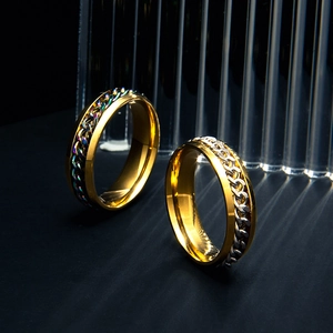 Detail of 6mm spinner chain rings in gold and silver finish on a luxury black stand