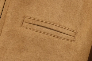 Detailed close-up of premium camel suede fabric and precise stitching on coat pocket